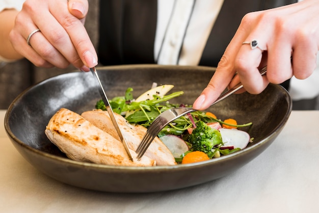 Person cutting gourmet chicken breast