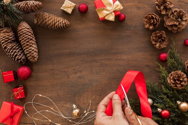 Person cutting red ribbon on table 