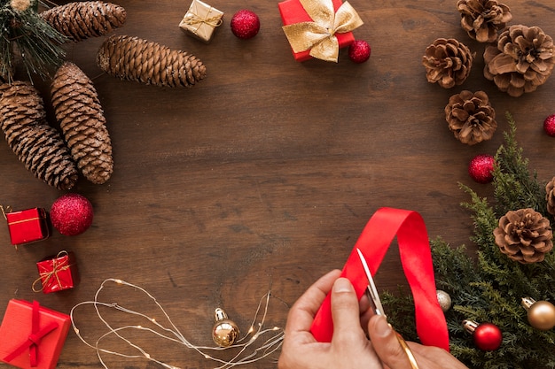 Person cutting red ribbon on table 