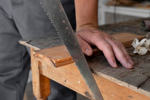 Person cutting wood close-up