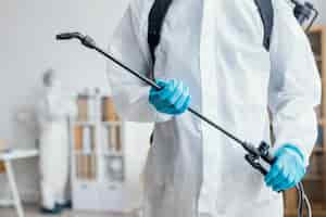 Free photo person disinfecting a dangerous area while wearing a protective suit