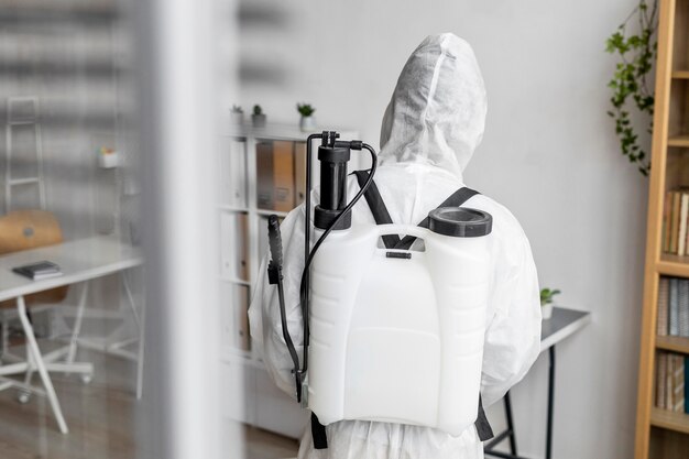 person disinfecting a restricted area