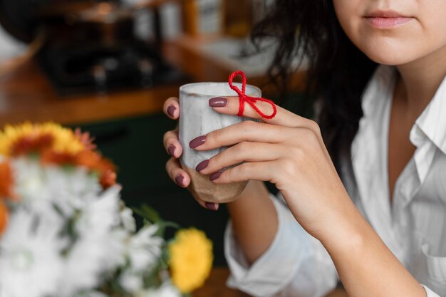 Person doing day-to- day activity while waring string on finger to remember something important