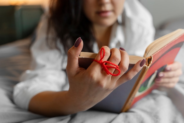 Person doing day-to- day activity while waring string on finger to remember something important