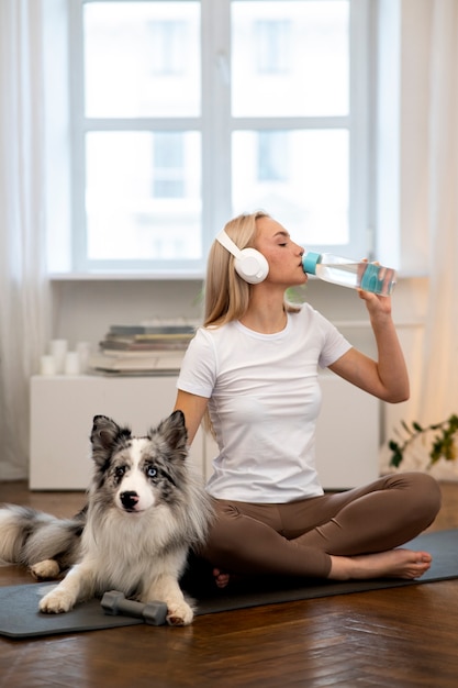 Person doing yoga accompanied by her pet