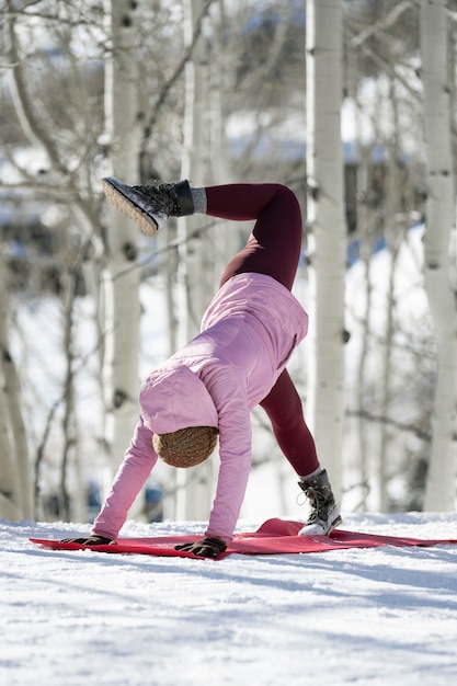 Free photo person doing yoga in cold and wintry weather