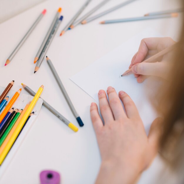 Person drawing with pencil on paper 