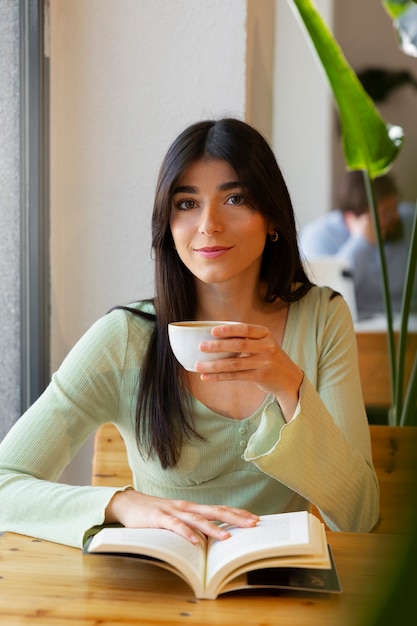 Free photo person drinking coffee in spacious cafeteria