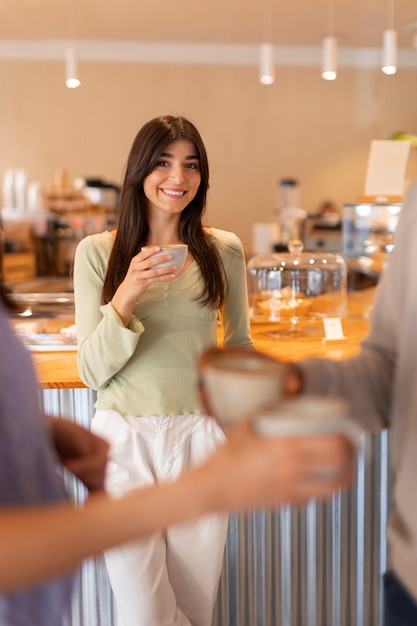 Free photo person drinking coffee in spacious cafeteria