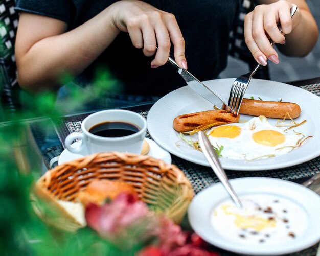 A person eating a breakfast at the table 1