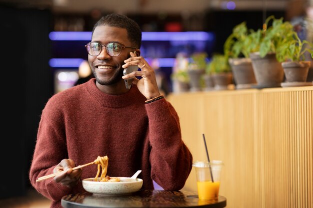 Person enjoying food at restaurant