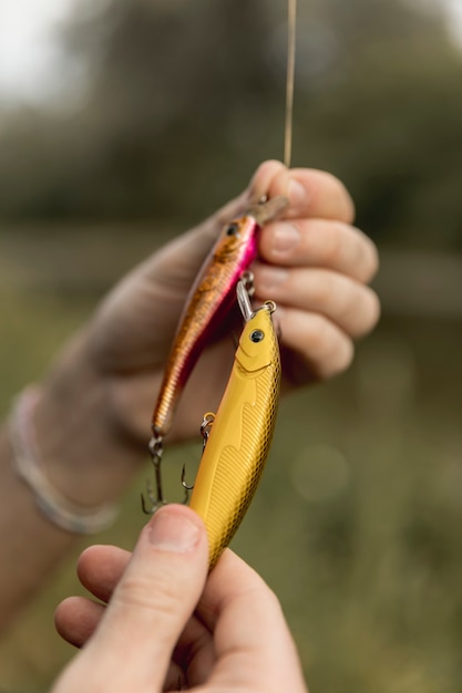 Free photo person fixing a fish hook