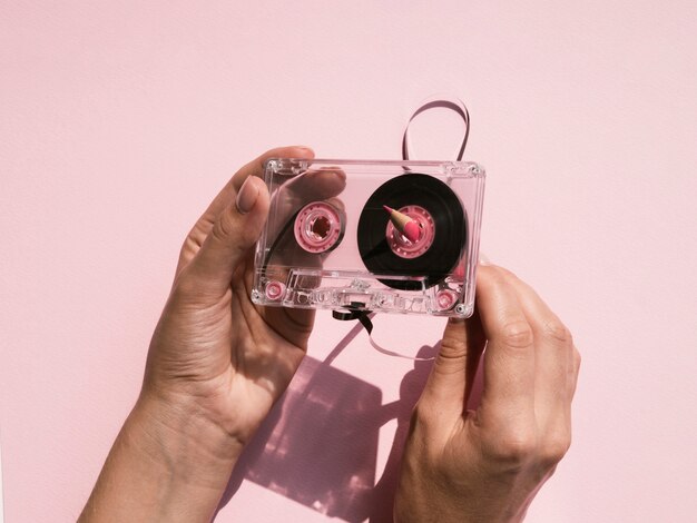 Person fixing up transparent cassette tape