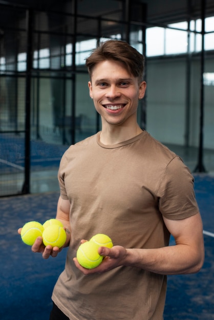 Person getting ready to play paddle tennis inside