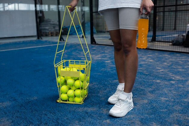 Person getting ready to play paddle tennis inside