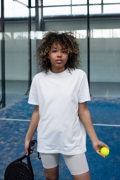 Person getting ready to play paddle tennis inside