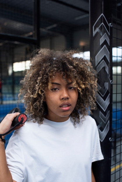 Person getting ready to play paddle tennis inside