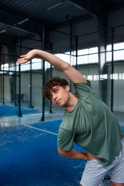 Free photo person getting ready to play paddle tennis inside