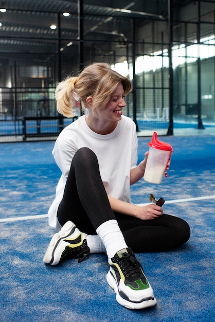 Person getting ready to play paddle tennis inside