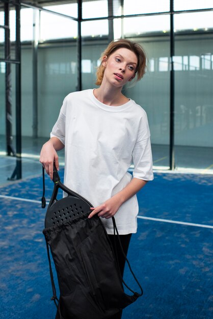 Person getting ready to play paddle tennis inside