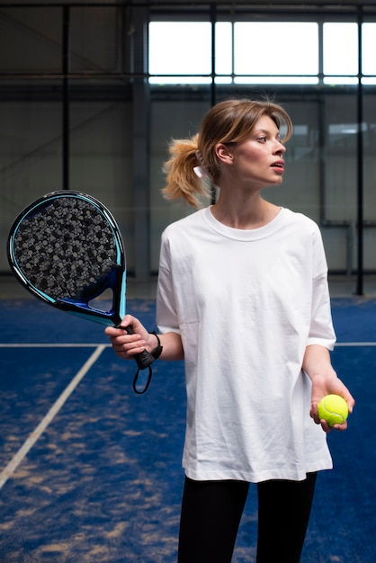 Person getting ready to play paddle tennis inside