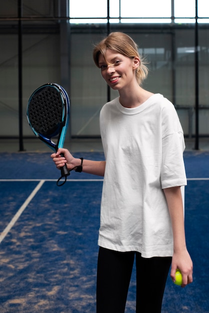 Free photo person getting ready to play paddle tennis inside