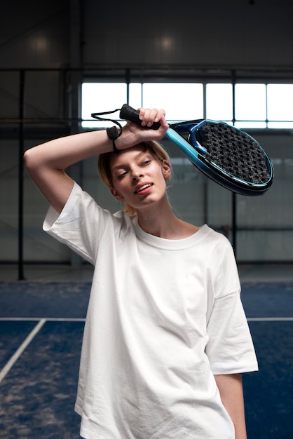 Person getting ready to play paddle tennis inside