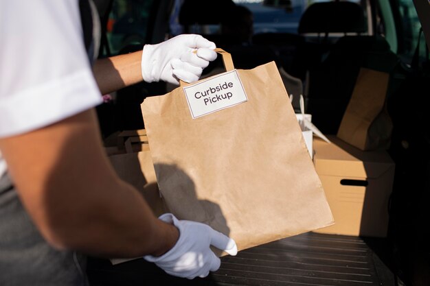 Person giving an order to a customer at a curbside pickup