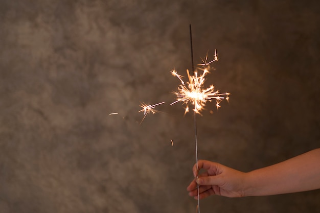 Person hand with flaming Bengal light in fog