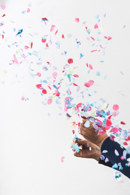 Person hands and colorful confetti