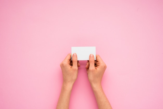 Person hands holding little paper 