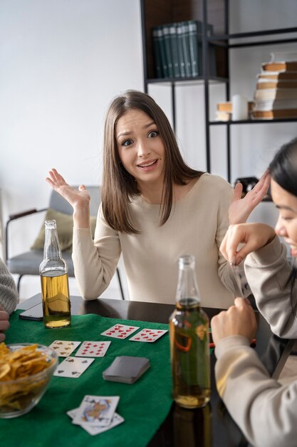 Person having fun while playing poker with friends