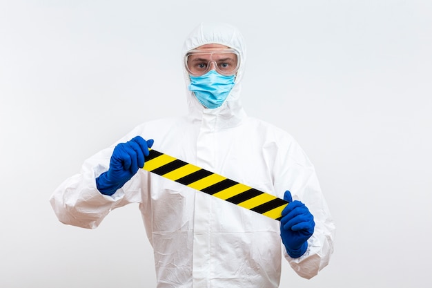 Free photo person in hazmat suit with tape