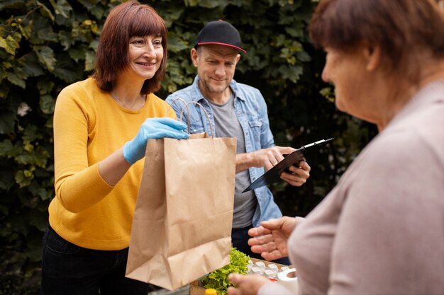 Person helping their elder neighbour