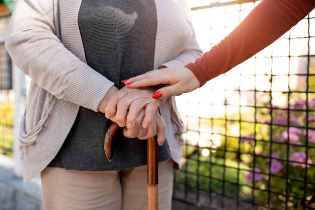 Free photo person helping their elder neighbour