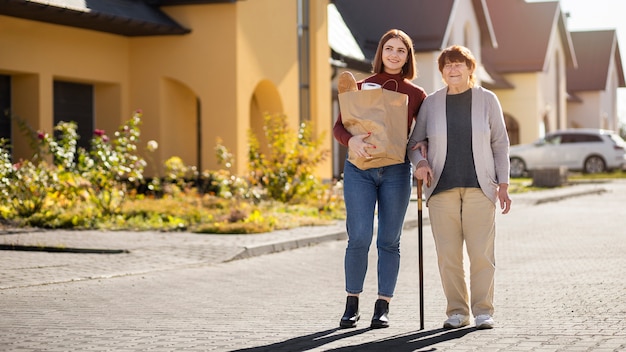 Person helping their elder neighbour