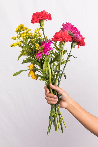 Person holding big flowers bouquet 