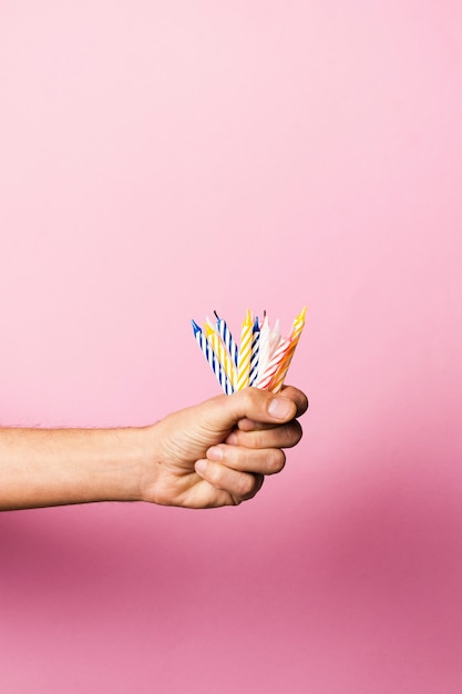 Free photo person holding birthday candles with copy space