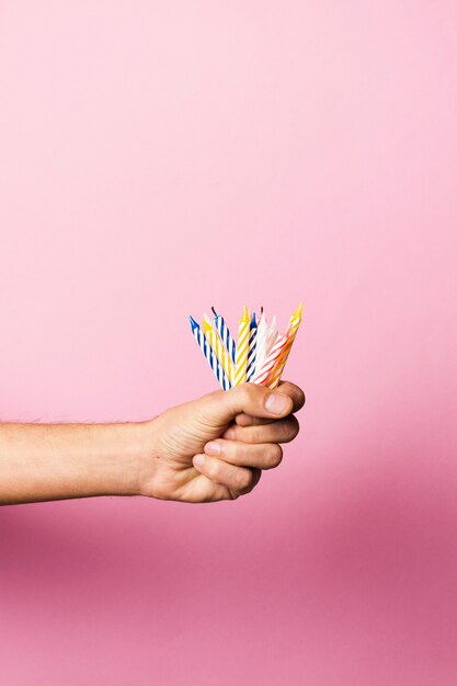 Person holding birthday candles with copy space