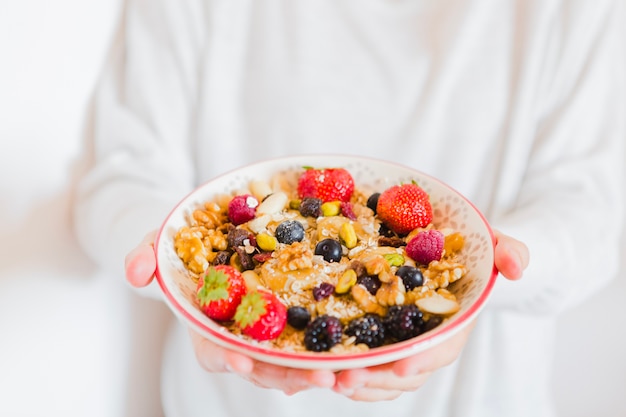 Free photo person holding bowl of oatmeal