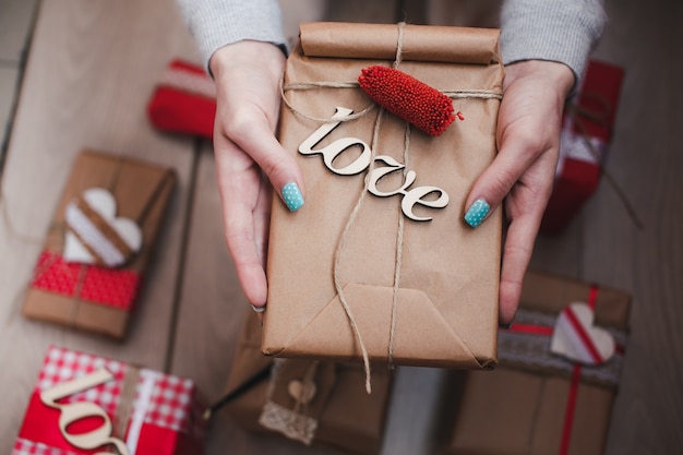 Free photo person holding brown package with word 