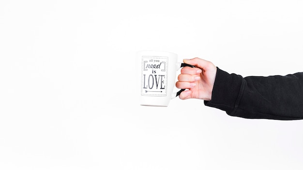 Person holding cup with all you need is love text