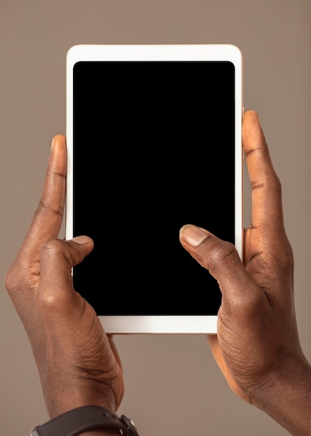 Free photo person holding digital tablet in vertical position