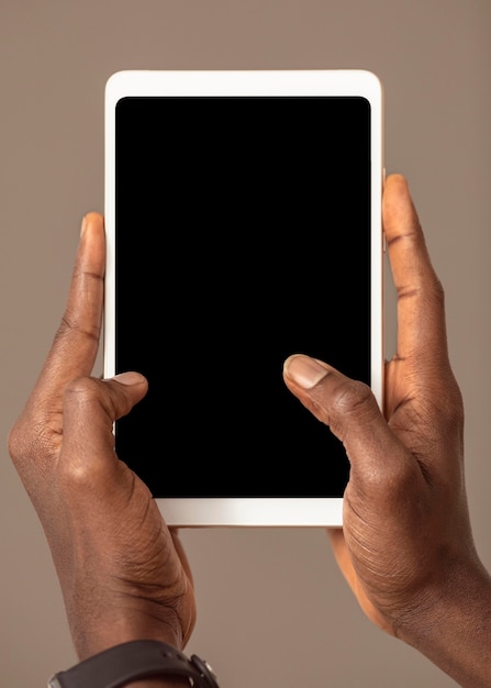 Person holding digital tablet in vertical position