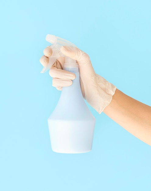 Person holding disinfection spray bottle
