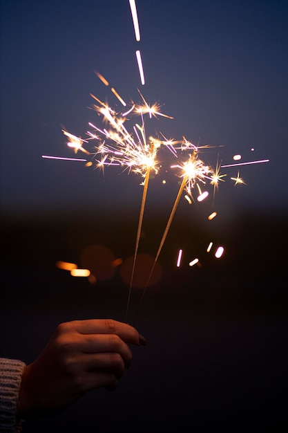 Free photo person holding a festive sparkler