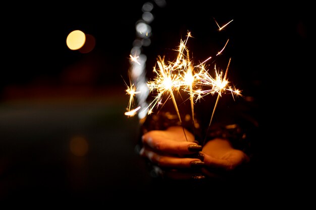 Person holding a festive sparkler