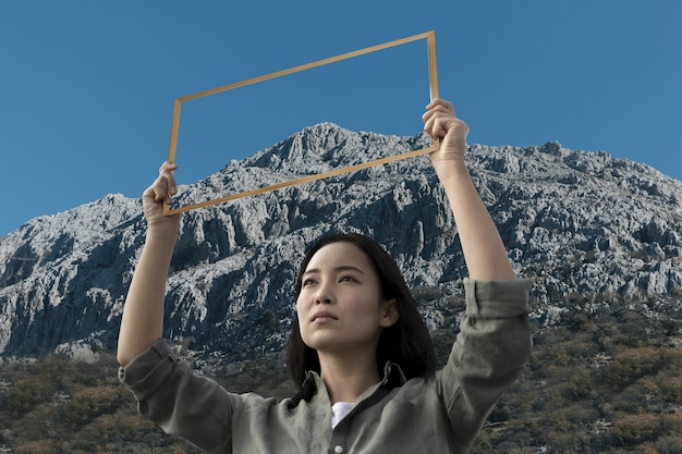 Person holding frame with open nature landscape concept