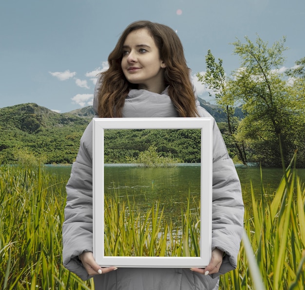 Person holding frame with open nature landscape concept