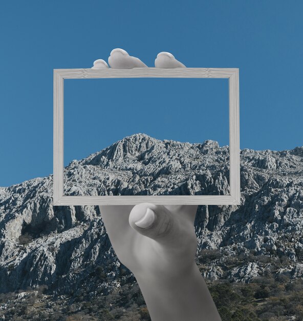 Person holding frame with open nature landscape concept